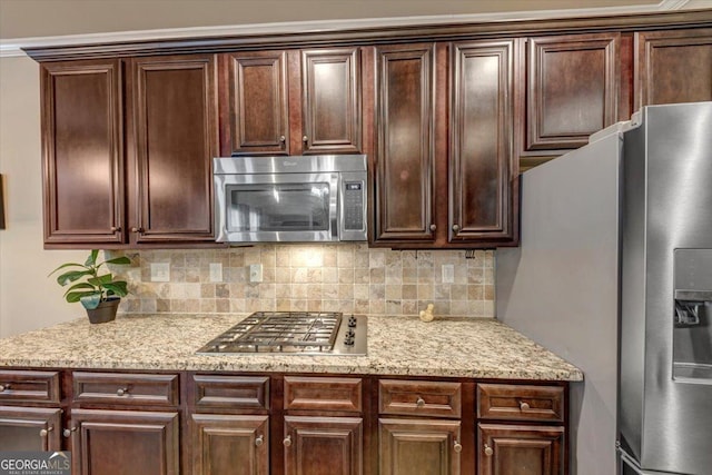 2376 Roberts View Trl, Buford, GA 30519 - kitchen featuring light stone countertops, tasteful backsplash, appliances with stainless steel finishes, and dark brown cabinetry