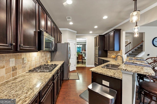 2376 Roberts View Trl, Buford, GA 30519 - kitchen with a breakfast bar area, dark brown cabinets, a sink, visible vents, and appliances with stainless steel finishes