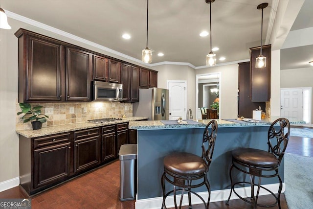 2376 Roberts View Trl, Buford, GA 30519 - kitchen featuring a kitchen bar, decorative backsplash, dark wood-style floors, dark brown cabinets, and appliances with stainless steel finishes