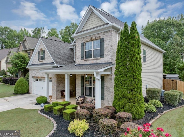 2376 Roberts View Trl, Buford, GA 30519 - view of front of house featuring driveway, brick siding, fence, covered porch, and roof with shingles
