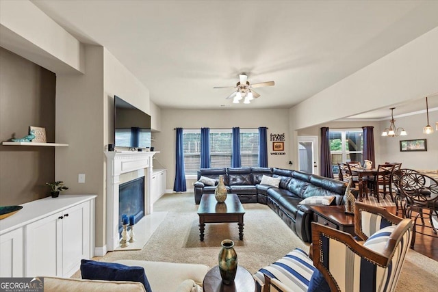 2376 Roberts View Trl, Buford, GA 30519 - living area featuring light carpet, baseboards, ceiling fan with notable chandelier, and a high end fireplace