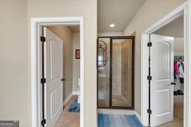 2376 Roberts View Trl, Buford, GA 30519 - full bathroom with toilet, tile patterned floors, baseboards, a shower stall, and a spacious closet