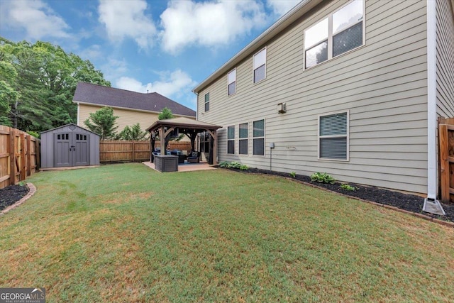 2376 Roberts View Trl, Buford, GA 30519 - back of property featuring a storage shed, a gazebo, a fenced backyard, an outdoor hangout area, and a yard