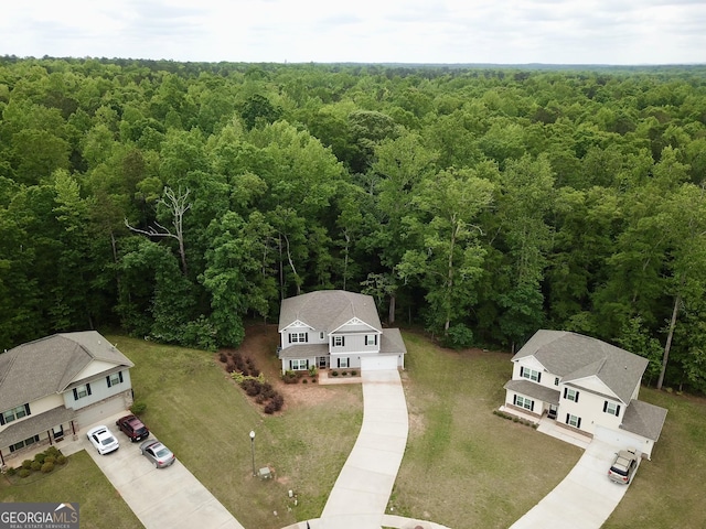 drone / aerial view featuring a forest view