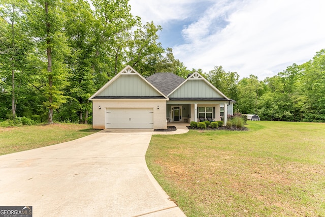 craftsman inspired home with an attached garage, driveway, a front yard, and covered porch