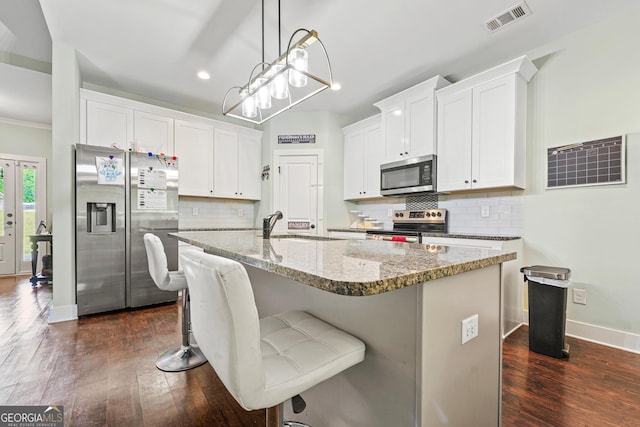 kitchen featuring visible vents, appliances with stainless steel finishes, recessed lighting, white cabinetry, and dark wood-type flooring