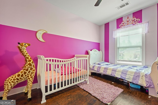 bedroom with ceiling fan, wood finished floors, and visible vents