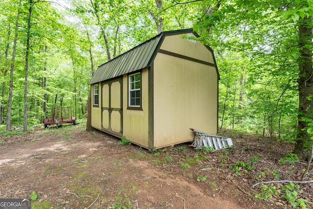 view of shed featuring a forest view