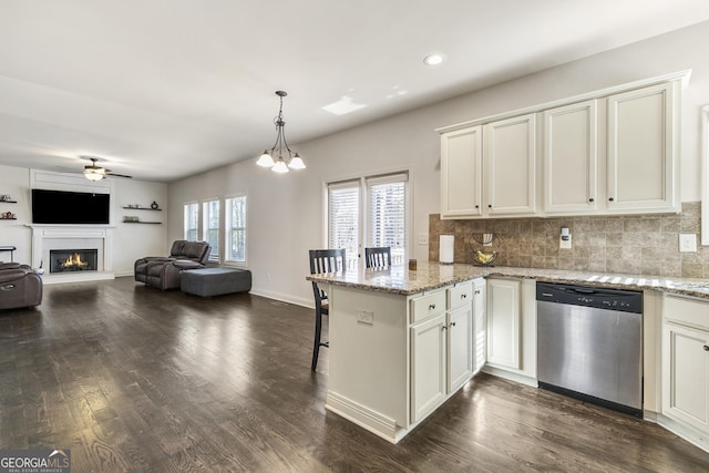 97 Fieldstone Ln, Dallas, GA 30132 - kitchen featuring stainless steel dishwasher, a ceiling fan, a peninsula, dark wood-style floors, and decorative backsplash