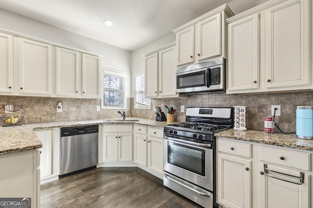 97 Fieldstone Ln, Dallas, GA 30132 - kitchen with stainless steel appliances, a sink, dark wood finished floors, light stone counters, and recessed lighting