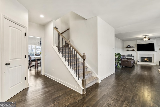 97 Fieldstone Ln, Dallas, GA 30132 - stairway with ceiling fan, wood finished floors, a lit fireplace, baseboards, and recessed lighting