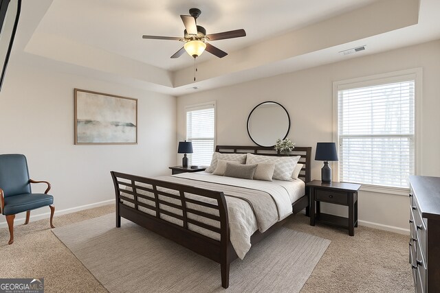 97 Fieldstone Ln, Dallas, GA 30132 - bedroom featuring a raised ceiling, light carpet, baseboards, and a ceiling fan