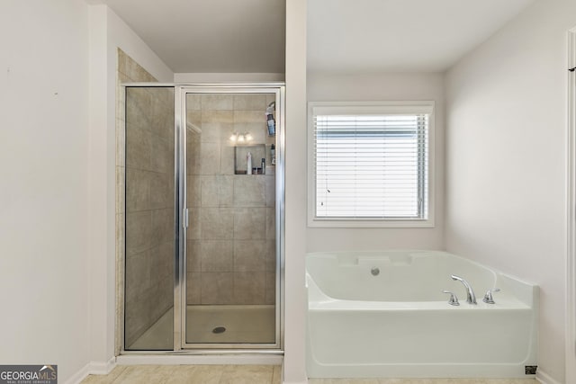 97 Fieldstone Ln, Dallas, GA 30132 - bathroom featuring a bath, a stall shower, baseboards, and tile patterned flooring