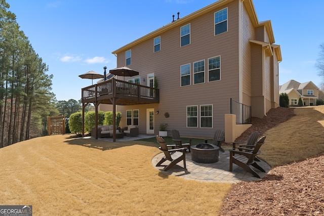 97 Fieldstone Ln, Dallas, GA 30132 - rear view of house featuring an outdoor living space with a fire pit, a patio, a wooden deck, and a lawn