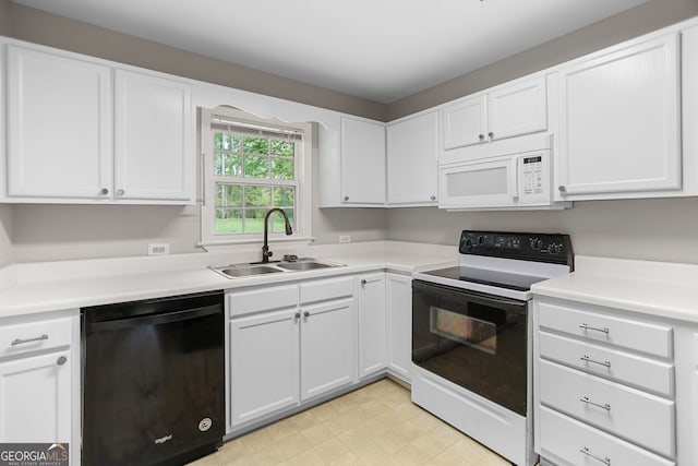 kitchen featuring electric range, black dishwasher, white microwave, white cabinetry, and a sink