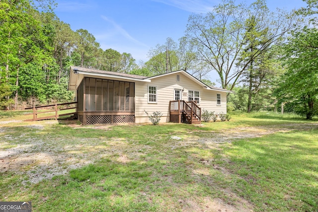 view of front of house featuring a sunroom and a front yard