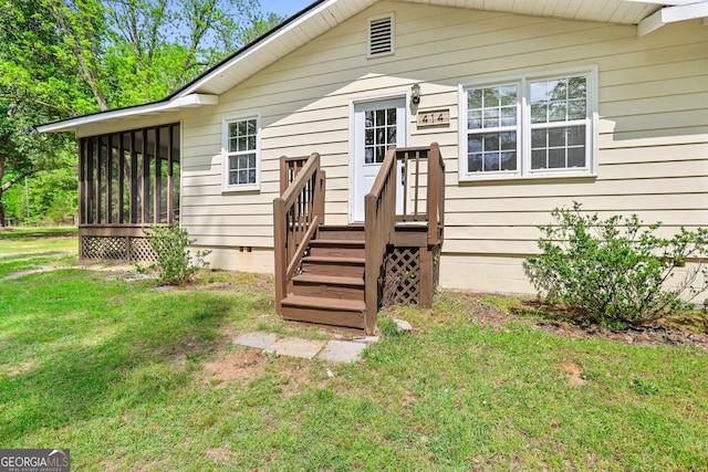 back of property featuring a yard and a sunroom