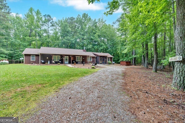 712 Honeysuckle Ln, Temple, GA 30179 - ranch-style house featuring dirt driveway, a chimney, a front yard, and covered porch