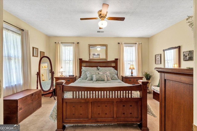 712 Honeysuckle Ln, Temple, GA 30179 - carpeted bedroom featuring multiple windows, a textured ceiling, and ceiling fan