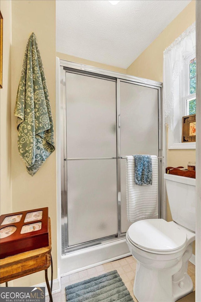 712 Honeysuckle Ln, Temple, GA 30179 - full bath featuring toilet, a shower stall, and tile patterned floors