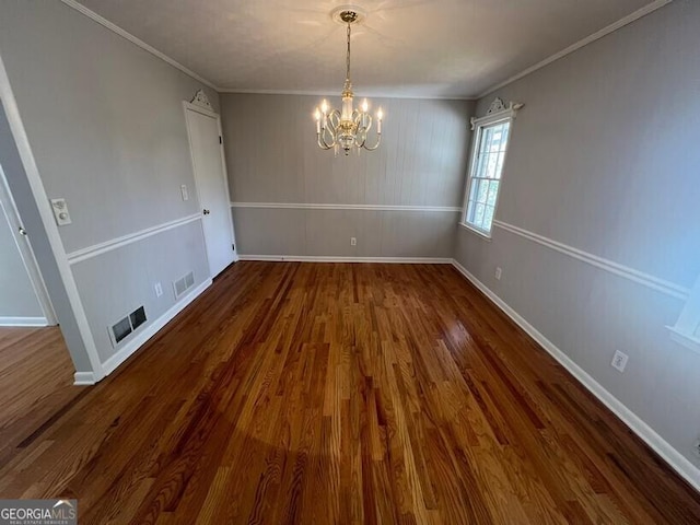 unfurnished dining area featuring dark wood-type flooring, baseboards, a notable chandelier, and visible vents