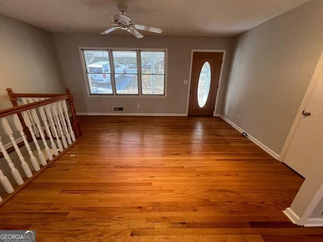 entrance foyer featuring baseboards, a ceiling fan, wood finished floors, and visible vents