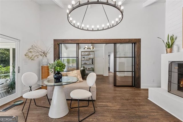 5785 Timberlane Ter, Sandy Springs, GA 30328 - dining space featuring beam ceiling, wood finished floors, baseboards, a chandelier, and a high ceiling