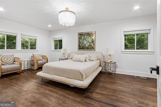 5785 Timberlane Ter, Sandy Springs, GA 30328 - bedroom featuring dark wood-style flooring, baseboards, visible vents, and an inviting chandelier