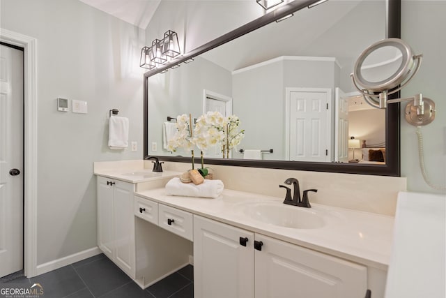 bathroom featuring double vanity, vaulted ceiling, a sink, and tile patterned flooring