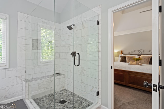 ensuite bathroom featuring a shower stall, a wealth of natural light, and ensuite bathroom