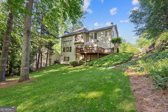 back of property with a lawn and a wooden deck