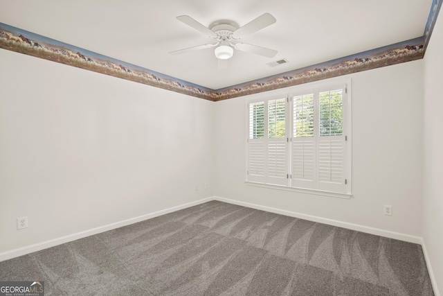 unfurnished room featuring carpet floors, a ceiling fan, and baseboards