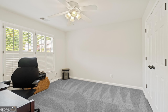carpeted office with baseboards, a ceiling fan, and visible vents