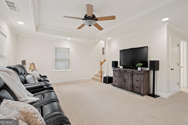 living room with carpet flooring, crown molding, ceiling fan, baseboards, and visible vents
