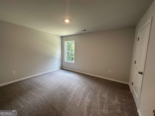 unfurnished room featuring carpet floors, baseboards, and visible vents
