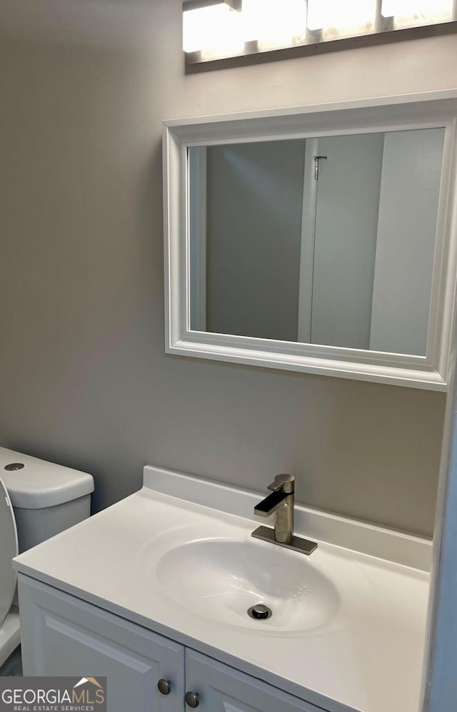 bathroom featuring vanity and toilet