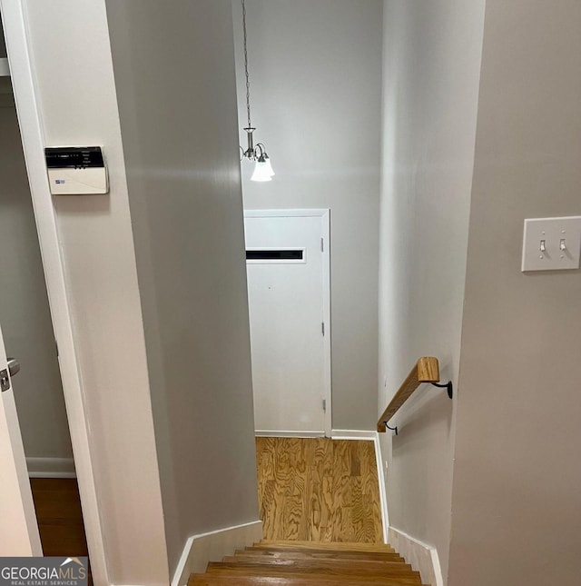 stairway with wood finished floors