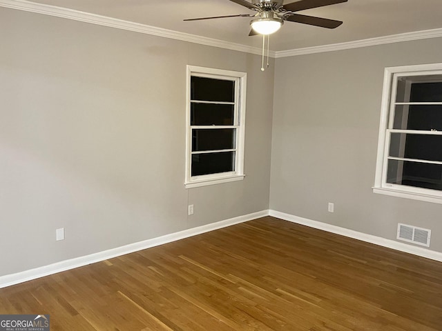 empty room featuring a ceiling fan, baseboards, ornamental molding, and wood finished floors