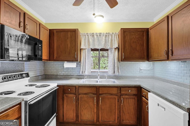 kitchen featuring white appliances, a sink, backsplash, a ceiling fan, and a textured ceiling