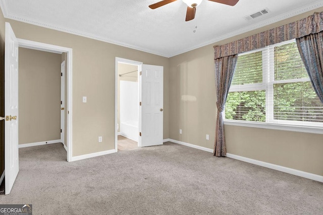 unfurnished bedroom with ornamental molding, carpet, baseboards, and a ceiling fan