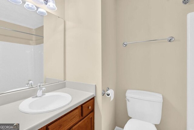 bathroom featuring toilet and vanity