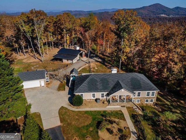 aerial view with a wooded view and a mountain view