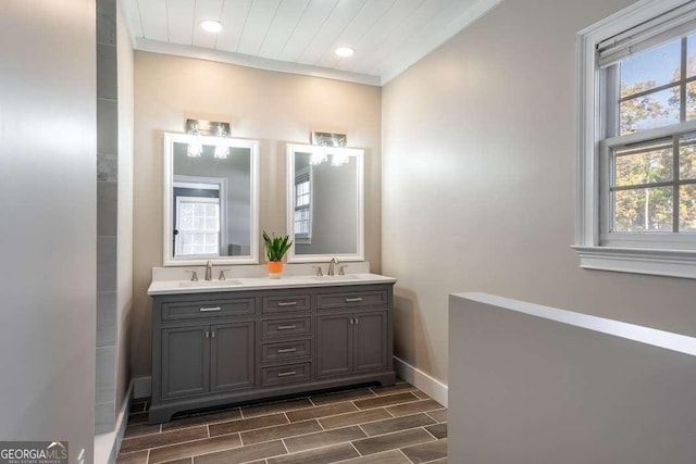 full bathroom featuring a sink, double vanity, recessed lighting, baseboards, and wood tiled floor