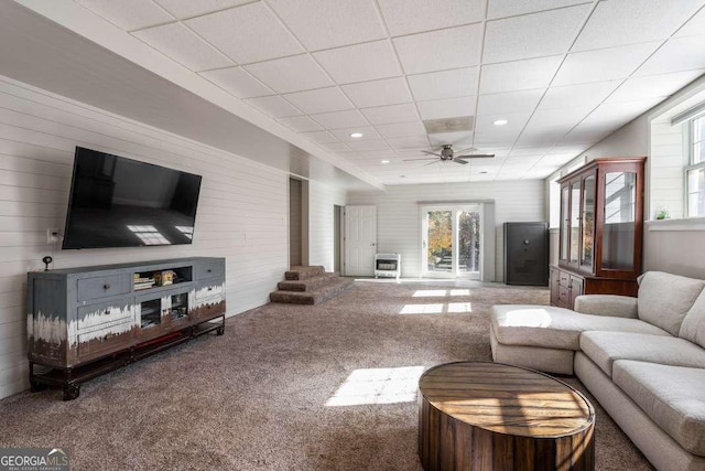 living area with plenty of natural light, carpet, ceiling fan, and a paneled ceiling