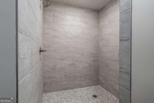 full bath with a tile shower
