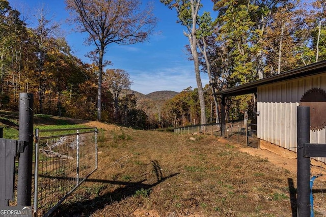 view of yard with fence and a mountain view