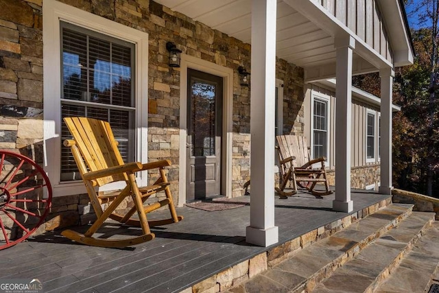 property entrance with a porch and stone siding