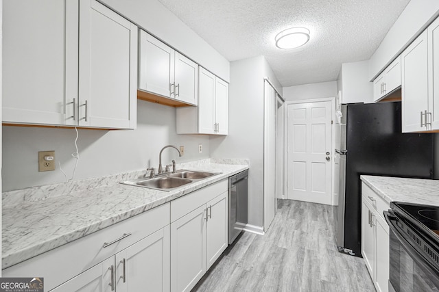 2930 Parc Lorraine, Lithonia, GA 30038 - kitchen with white cabinetry, a textured ceiling, appliances with stainless steel finishes, and light wood finished floors
