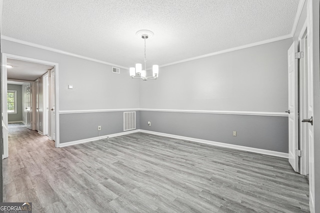 2930 Parc Lorraine, Lithonia, GA 30038 - unfurnished dining area featuring a notable chandelier, a textured ceiling, wood finished floors, visible vents, and ornamental molding