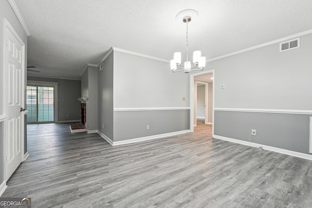 2930 Parc Lorraine, Lithonia, GA 30038 - unfurnished dining area featuring crown molding, a textured ceiling, baseboards, and wood finished floors